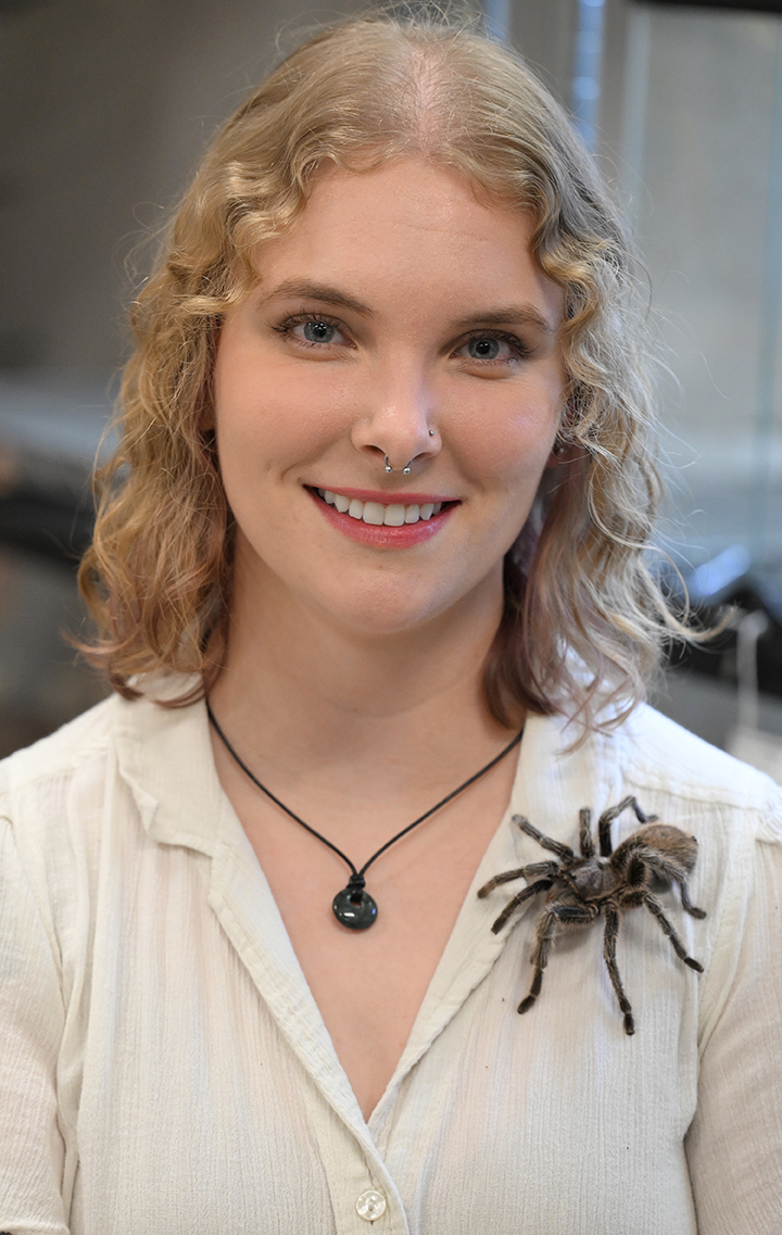 Em Jochim with a tarantula on her white blouse. 