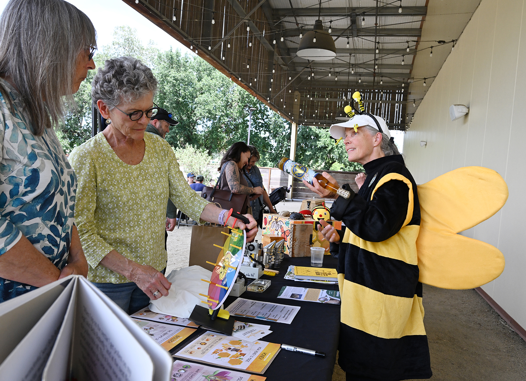 Wendy Mather, co-program manager of CAMBP, talks to visitors at the mini-festival at The Hive, Woodland. (Photo by Kathy Keatley Garvey)