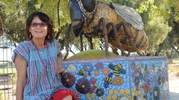 "Rock artist" Donna Billick by her sculpture, "Miss Bee Haven"