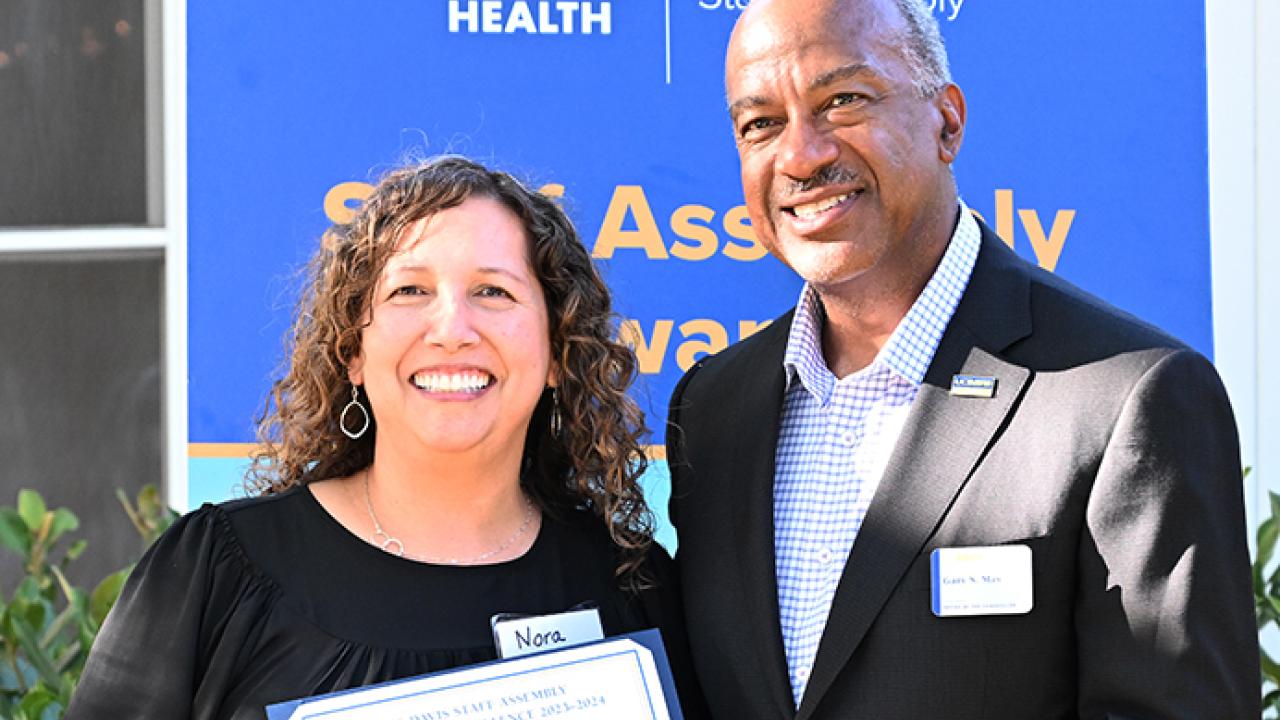 Nora Orozco, chief administrative officer for the Department of Entomology and Nematology and the Department of Plant Pathology, receives congratulations UC Davis Chancellor Gary May. She was named a recipient of a UC Davis Staff Assembly Citation for Excellence for outstanding supervison. (Photo by Kathy Keatley Garvey)