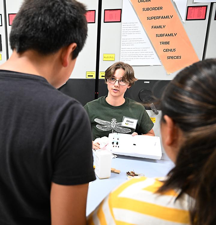 UC Davis student Oliver Smith talks to visitors about preserving specimens. (Photo by Kathy Keatley Garvey)