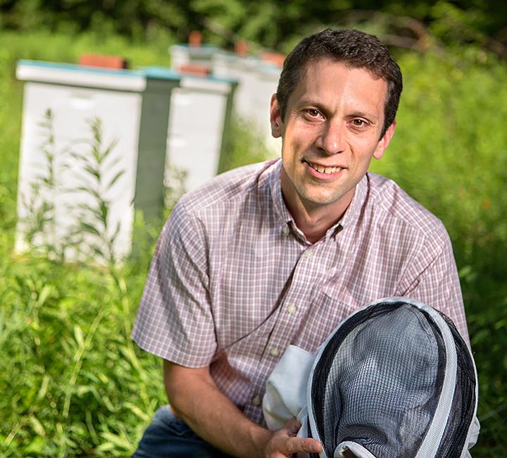 Scott McArt, associate professor, Cornell University, in front of breeder colonies