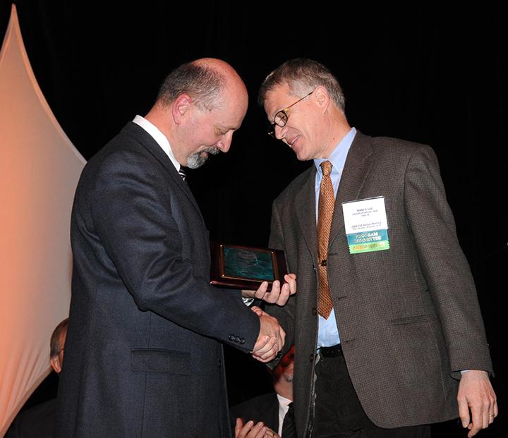 One of the images in the Legends piece: Walter Leal (right), newly elected Fellow (2008) of the Entomological Society of America, receives congratuations from President Mike Gray. (Photo by Kathy Keatley Garvey.)