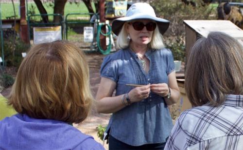 Chris Casey, manager of the UC Davis Bee Haven, talks to visitors
