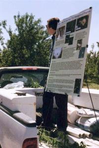 Frank Zalom, standing in the back of a pickup truck, giving a talk about almonds.