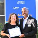 Nora Orozco, chief administrative officer for the Department of Entomology and Nematology and the Department of Plant Pathology, receives congratulations UC Davis Chancellor Gary May. She was named a recipient of a UC Davis Staff Assembly Citation for Excellence for outstanding supervison. (Photo by Kathy Keatley Garvey)