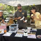 The CAMBP team ready to greet the crowd. From left are Wendy Mather an Kian Nikzad, co-program managers of CAMBP; and Samantha Murray, education and garden coordinator of the UC Davis Bee Haven. (Photo by Kathy Keatley Garvey)